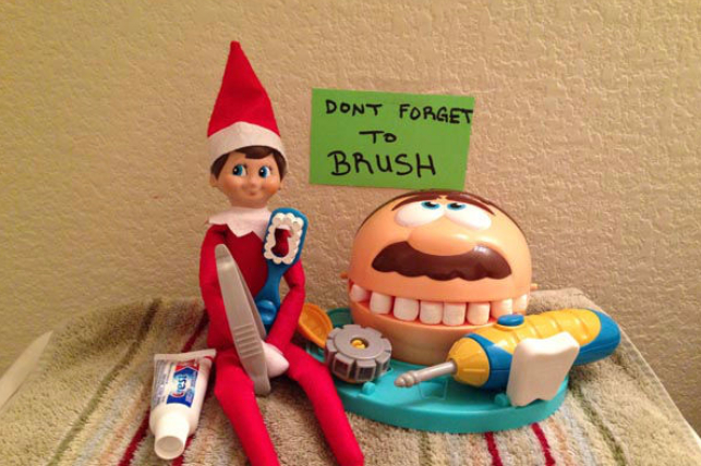 Elf on the shelf plays with toy dental tools