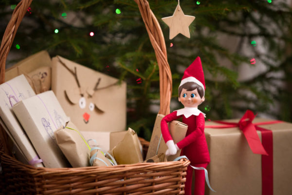 Elf on the shelf next to gifts