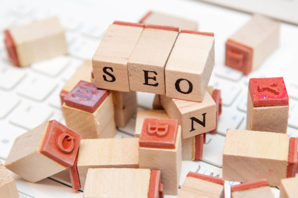 blocks spell out"SEO" atop a pile of illegible blocks