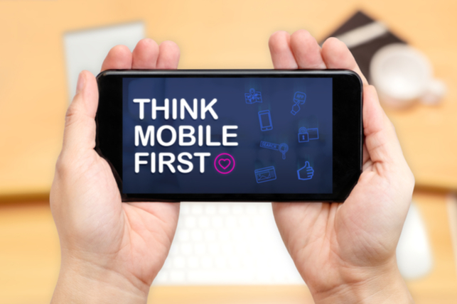 hands holding phone that says "think mobile first"