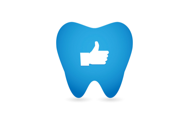 thumbs up icon set inside a cartoon tooth border